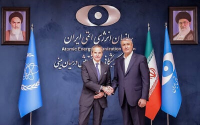 This handout picture made available by the Iranian Atomic Organization (AEOI) office shows the Director-General of the International Atomic Energy Agency (IAEA) Rafael Grossi (L) being received by the head of the AEOI Mohammad Eslami (R) in Tehran on April 17, 2025. (Atomic Energy Organization of Iran / AFP)