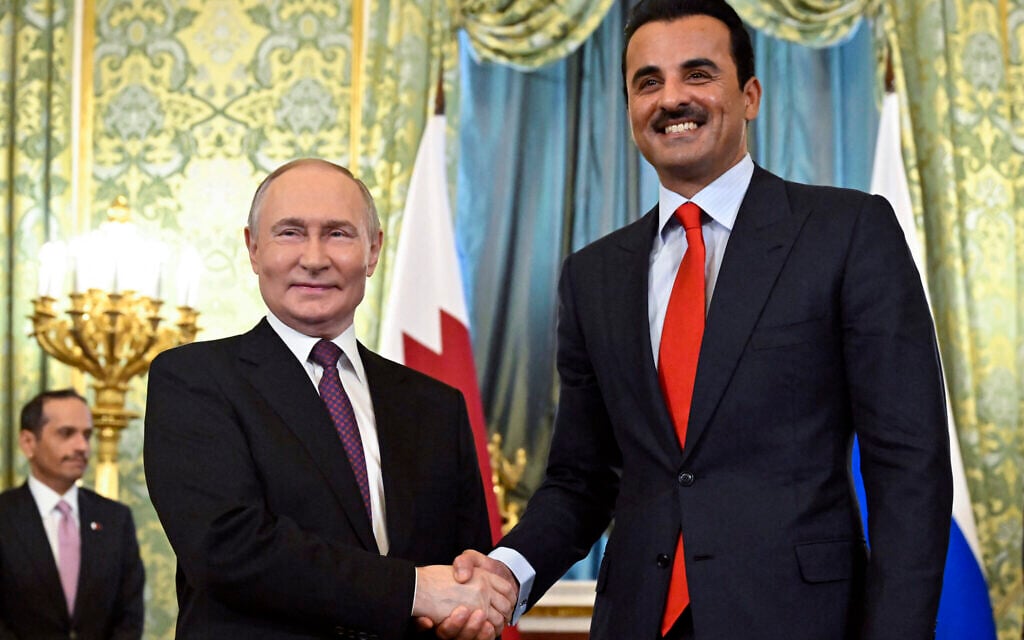 Russian President Vladimir Putin shakes hands with Qatar's Emir Sheikh Tamim bin Hamad al-Thani during a meeting at the Kremlin in Moscow on April 17, 2025. (Photo by Alexander NEMENOV / POOL / AFP)