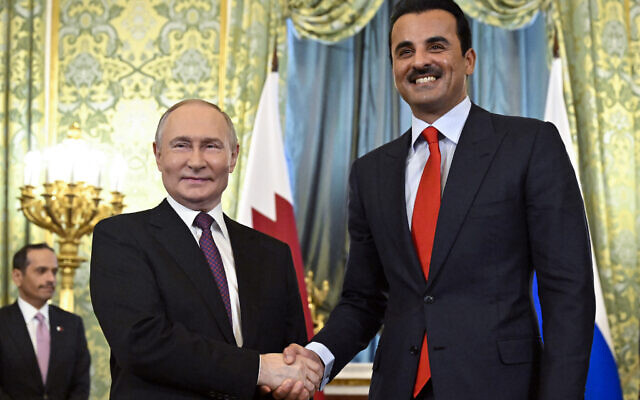 Russian President Vladimir Putin shakes hands with Qatar's Emir Sheikh Tamim bin Hamad al-Thani during a meeting at the Kremlin in Moscow on April 17, 2025. (Photo by Alexander NEMENOV / POOL / AFP)