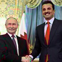 Russian President Vladimir Putin, left, shakes hands with Qatar's Emir Sheikh Tamim bin Hamad Al-Thani during a meeting at the Kremlin in Moscow, Russia, April 17, 2025. (Alexander Nemenov / Pool / AFP)