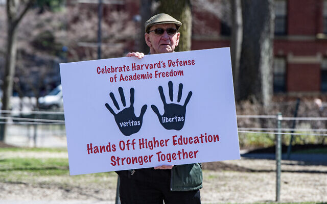 A Harvard Faculty member holds a sign as he exits Harvard Yard after a rally was held against US President Donald Trump's attacks on Harvard University at Harvard University in Cambridge, Massachusetts on April 17, 2025. (Joseph Prezioso / AFP) A Harvard Faculty member holds a sign as he exits Harvard Yard after a rally was held against US President Donald Trump's attacks on Harvard University at Harvard University in Cambridge, Massachusetts on April 17, 2025. (Joseph Prezioso / AFP)