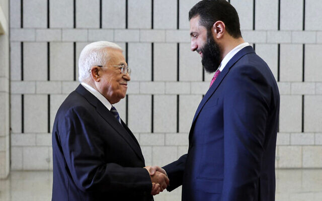 Syria's interim President Ahmed al-Sharaa (R) receiving Palestinian Authority President Mahmoud Abbas in Damascus on April 18, 2025. (SANA / AFP)