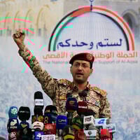 Brigadier Yahya Saree Qasim, the spokesman for Yemen's Houthis, gestures as he speaks during a protest to denounce US airstrikes on Yemen, in Sanaa on April 18, 2025. (MOHAMMED HUWAIS / AFP)