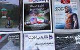This picture shows newspaper front page headlines at a kiosk in Tehran on April 19, 2025, featuring the Iran-US talks on the Iranian nuclear program set to begin in Rome. (ATTA KENARE / AFP)