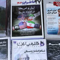 This picture shows newspaper front page headlines at a kiosk in Tehran on April 19, 2025, featuring the Iran-US talks on the Iranian nuclear program set to begin in Rome. (ATTA KENARE / AFP)