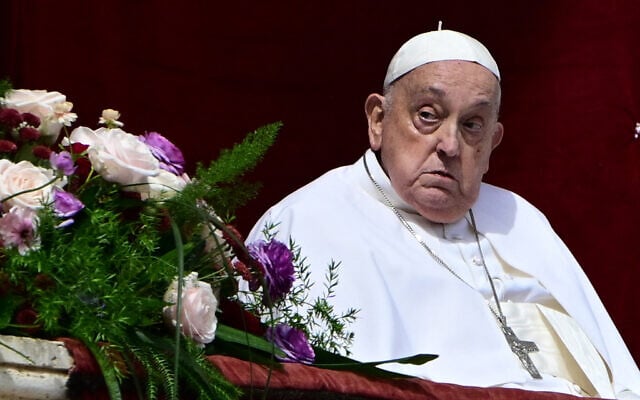 Pope Francis stands on the main balcony of St. Peter's basilica during the Urbi et Orbi message and blessing to the city and the world as part of Easter celebrations, at St Peter's square in the Vatican on April 20, 2025. (Photo by Tiziana FABI / AFP)