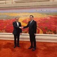Chinese Vice Premier Ding Xuexiang (R) welcoming Iran's Foreign Minister Abbas Araghchi in Beijing on April 23, 2025. (Iranian Foreign Ministry / AFP)