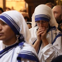 Nuns mourn during a memorial mass for Pope Francis at the Church of the Holy Sepulchre in Jerusalem on April 23, 2025. (AHMAD GHARABLI / AFP)