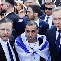 President Isaac Herzog (L) poses with fomer hostage Eli Sharabi (C), and Poland's President Andrzej Duda (R) in front of the 'Arbeit macht frei' (Work will set you free) gate at the Auschwitz Birkenau concentration camp in Oswiecim, Poland, on April 24, 2025, prior to the March of the Living (Wojtek Radwanski/AFP)