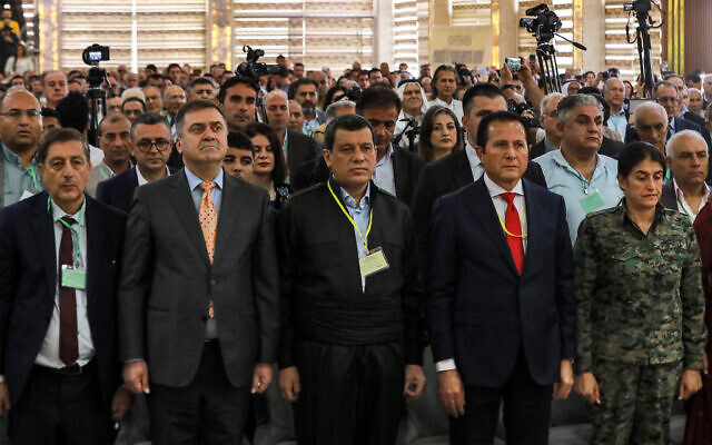 Mazloum Abdi (3rd-R), commander-in-chief of the Syrian Democratic Forces (SDF), and Hamid Darbandi (2nd-R), envoy of Iraqi Kurdish politician Masoud Barzani (leader of the Kurdistan Democratic Party), attend the pan-Kurdish "Unity and Consensus" conference in Qamishli in northeastern Syria on April 26, 2025. (Delil SOULEIMAN / AFP)