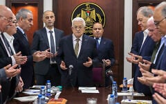 This handout picture released by the Palestinian Authority's Press Office shows President Mahmoud Abbas (C) leading prayers next to then-PLO Secretary General Hussein al-Sheikh (3rd-L) during a meeting of the organization's Executive Committee in Ramallah on April 26, 2025. (Thaer Ghanaim/PPO/AFP)