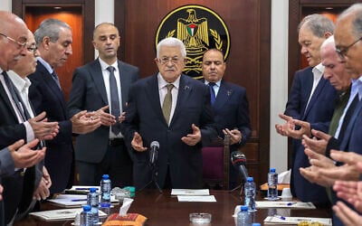 This handout picture released by the Palestinian Authority's Press Office shows President Mahmoud Abbas (C) leading prayers next to then-PLO Secretary General Hussein al-Sheikh (3rd-L) during a meeting of the organization's Executive Committee in Ramallah on April 26, 2025. (Thaer Ghanaim/PPO/AFP)