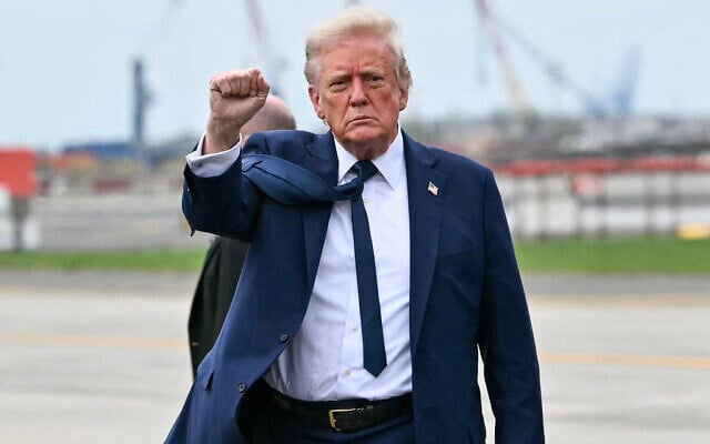 US President Donald Trump pumps his fist as he steps off Air Force upon arrival at Newark Liberty International Airport in Newark, New Jersey on April 26, 2025. (Mandel NGAN / AFP)