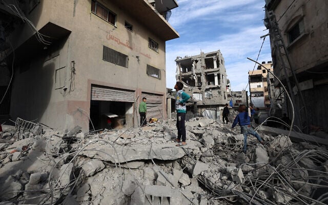Palestinian children walk amid the rubble of a building destroyed in an Israeli strike at the Bureij refugee camp in the central Gaza Strip on April 27, 2025. (Eyad BABA / AFP)