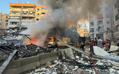 Lebanese rescuers extinguish a fire at a site hit in an Israeli strike following evacuation orders in Beirut's southern suburb on April 27, 2025. (AFP)