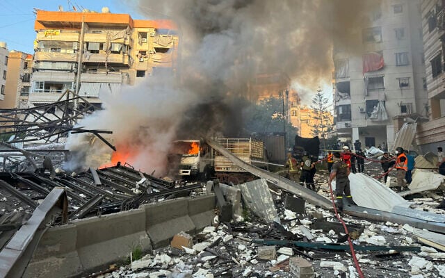 Lebanese rescuers extinguish a fire at a site hit in an Israeli strike following evacuation orders in Beirut's southern suburb on April 27, 2025. (AFP)