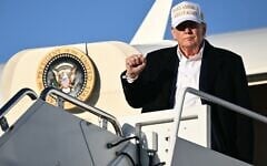 US President Donald Trump raises a fist as he steps off Air Force One upon arrival at Joint Base Andrews in Maryland on April 27, 2025. (Mandel Ngan/AFP)