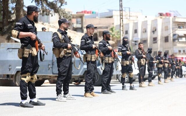 Syrian security forces standing guard in a street in the mostly Druze and Christian Jaramana suburb of Damascus on April 29, 2025. (Syrian Interior Ministry Facebook Page / AFP)