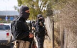 Security forces of Syria's new Islamist government stand guard on the road leading to the airport, in the Damascus' suburb of Jaramana on April 29, 2025. (Rami al SAYED / AFP)
