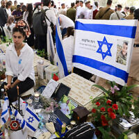 People visit the graves of Israeli soldiers during the Memorial Day commemoration for fallen soldiers at the Mount Herzl military cemetery in Jerusalem on April 30, 2025. (Photo by Menahem Kahana / AFP)