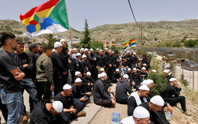 Druze men demonstrate in solidarity with the Syrian Druze community near the border barrier in the village of Majdal Shams in the Golan Heights on April 30, 2025 (Jalaa MAREY / AFP)