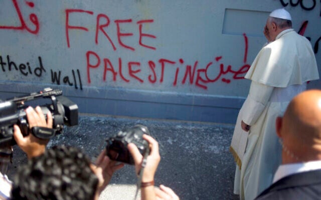 Pope Francis prays at Israel's security barrier on his way to a Mass in Manger Square next to the Church of the Nativity, traditionally believed to be the birthplace of Jesus Christ, in the West Bank city of Bethlehem, Sunday, May 25, 2014. (AP Photo/Ariel Schalit, file)