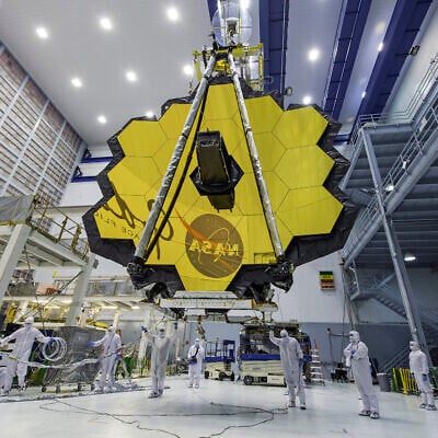 FILE - In this photo provided by NASA, technicians lift the mirror of the James Webb Space Telescope using a crane, April 13, 2017, at the Goddard Space Flight Center in Greenbelt, Md. (Laura Betz/NASA via AP, File)