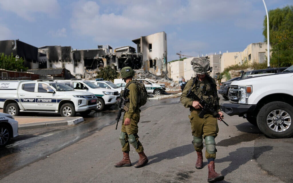 Israeli soldiers walk near Sderot's police station that was overrun by Hamas terrorists during the October 7 onslaught, on October 8, 2023. (AP Photo/Ohad Zwigenberg)