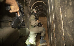 Israeli soldiers escort the media to an underground tunnel found underneath Shifa Hospital in Gaza City, Nov. 22, 2023. (AP/Victor R. Caivano)