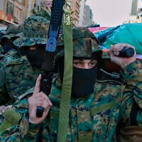 Al-Jama'a al-Islamiyya (Islamic Group) members carry the body of operative Mohammad Riad Mohyeldin, who was killed in an Israeli strike, during his funeral procession in Beirut, Lebanon, March 12, 2024. (AP Photo/Bilal Hussein)