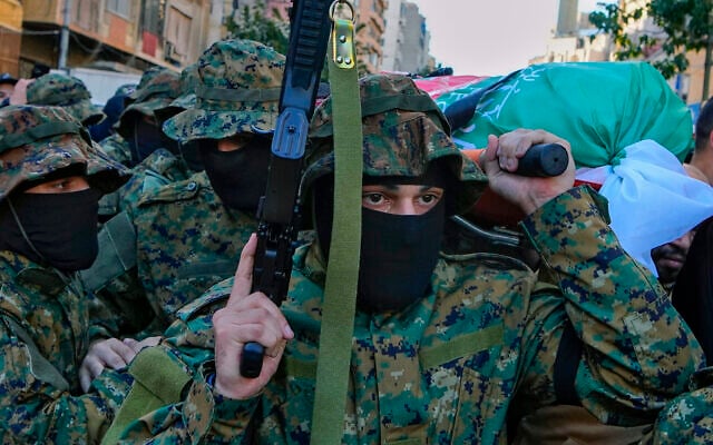 Al-Jama'a al-Islamiyya (Islamic Group) members carry the body of operative Mohammad Riad Mohyeldin, who was killed in an Israeli strike, during his funeral procession in Beirut, Lebanon, March 12, 2024. (AP Photo/Bilal Hussein)