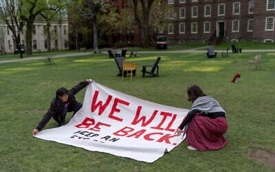 Pro-Palestinian demonstrators unfurl a banner on a lawn after an encampment protesting Israel over the Gaza war with Hamas was taken down at Brown University, April 30, 2024, in Providence, Rhode Island. (AP Photo/David Goldman)
