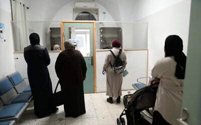 Women wait to be served at a health clinic run by the United Nations agency for Palestinian refugees, known as UNRWA, in the Old City of Jerusalem, Tuesday, January 28, 2025. (AP/Mahmoud Illean)