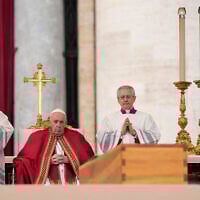 Pope Francis sits by the coffin of late Pope Emeritus Benedict XVI in St. Peter's Square during a funeral mass at the Vatican, on January 5, 2023. (Andrew Medichini/AP)