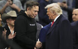 Elon Musk, left, shakes hands with US President Donald Trump at the finals for the NCAA wrestling championship, on March 22, 2025, in Philadelphia, Pennsylvania. (AP Photo/Matt Rourke)