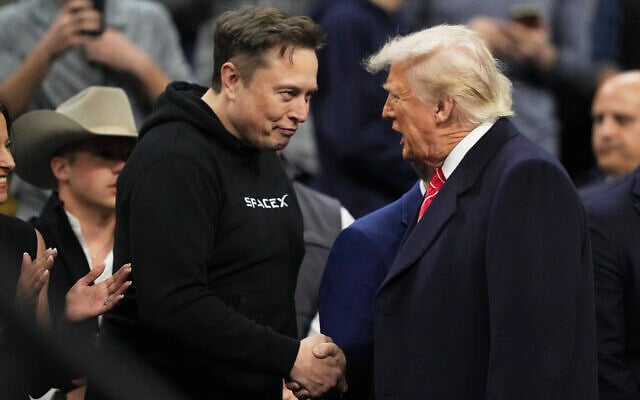 Elon Musk, left, shakes hands with US President Donald Trump at the finals for the NCAA wrestling championship, on March 22, 2025, in Philadelphia, Pennsylvania. (AP Photo/Matt Rourke) Elon Musk, left, shakes hands with US President Donald Trump at the finals for the NCAA wrestling championship, on March 22, 2025, in Philadelphia, Pennsylvania. (AP Photo/Matt Rourke)