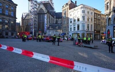 Police officers stand behind a cordoned off area after a stabbing near Dam Square in central Amsterdam, March 27, 2025. (AP Photo/Peter Delong)