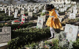 A Yemeni girl visits the graves of Houthis during Eid al-Fitr marking the end of the holy fasting month of Ramadan in Sanaa, Yemen, March 30, 2025. (Osamah Abdulrahman/AP)