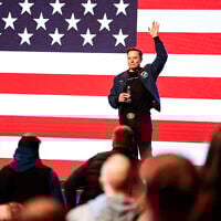 Elon Musk waves to supporters during a town hall Sunday, March 30, 2025, in Green Bay, Wisconsin. (AP Photo/Jeffrey Phelps)