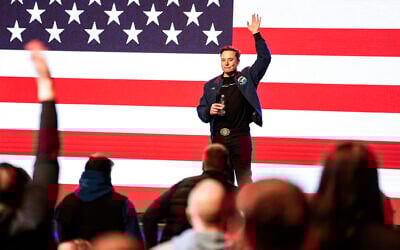 Elon Musk waves to supporters during a town hall Sunday, March 30, 2025, in Green Bay, Wisconsin. (AP Photo/Jeffrey Phelps)