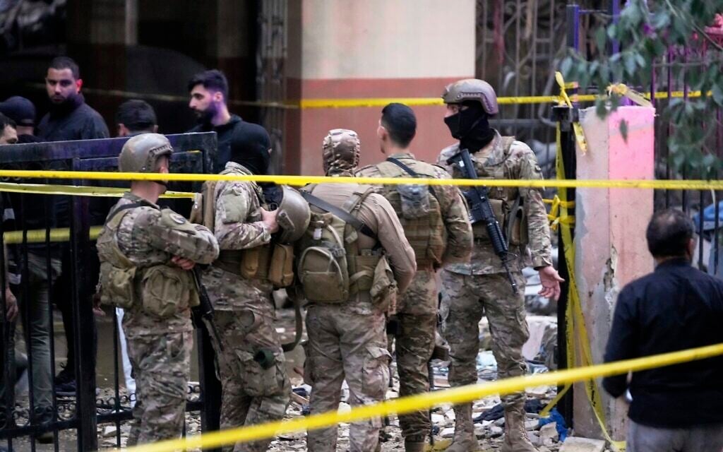 Lebanese army soldiers cordon the area of an Israeli targeted strike on an apartment building in Dahiyeh, in the southern suburb of Beirut, Lebanon, early Tuesday, April 1, 2025.(AP Photo/Hussein Malla)