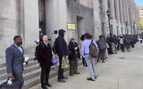 Hundreds of employees wait in line wrapped around the outside of the Health and Human Services headquarters building, in Washington, April 1, 2025. (Amanda Seitz/AP)