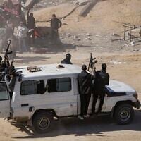 Hamas operatives seen as aid trucks arrive in Rafah, Gaza Strip, January 21, 2025. (Jehad Alshrafi/AP)