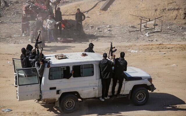 Hamas operatives seen as aid trucks arrive in Rafah, Gaza Strip, January 21, 2025. (Jehad Alshrafi/AP)