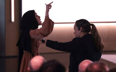 A pro-Palestinian demonstrator, Ibtihal Aboussad, is escorted away by security as she interrupts Microsoft AI CEO Mustafa Suleyman during a presentation of the company's AI assistant, Copilot, ahead of a 50th Anniversary presentation at Microsoft headquarters, Friday, April 4, 2025, in Redmond, Washington (AP Photo/Jason Redmond)
