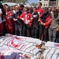 Mourners gather around the bodies of 8 Red Crescent emergency responders, recovered in Rafah a week after an Israeli attack, as they are transported for burial from a hospital in Deir al-Balah, Gaza Strip, on March 31, 2025. (AP Photo/Abdel Kareem Hana,File)