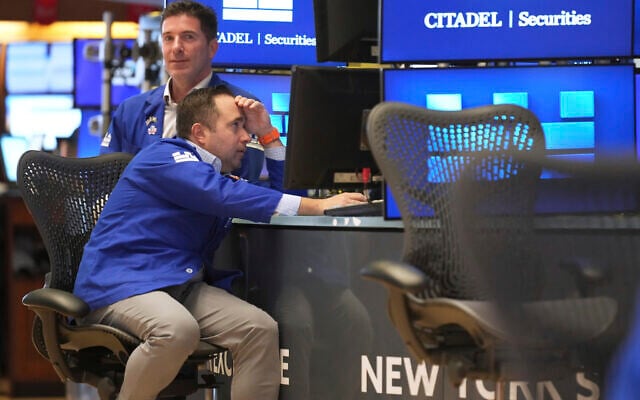 Traders work on the floor at the New York Stock Exchange in New York, Tuesday, April 8, 2025. (AP Photo/Seth Wenig)