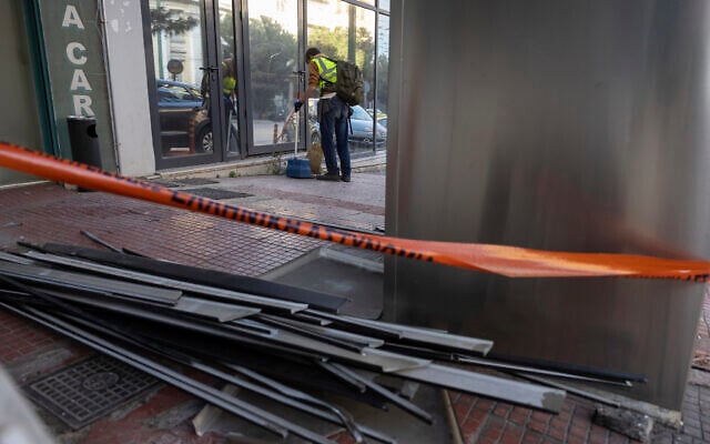 A municipal worker cleans the area outside Hellenic Train headquarters, Greece's main railway company, following a bomb explosion Friday night causing causing limited damage but no injuries, in Athens, Greece, on April 12, 2025. (AP Photo/Yorgos Karahalis) A municipal worker cleans the area outside Hellenic Train headquarters, Greece's main railway company, following a bomb explosion Friday night causing causing limited damage but no injuries, in Athens, Greece, on April 12, 2025. (AP Photo/Yorgos Karahalis)
