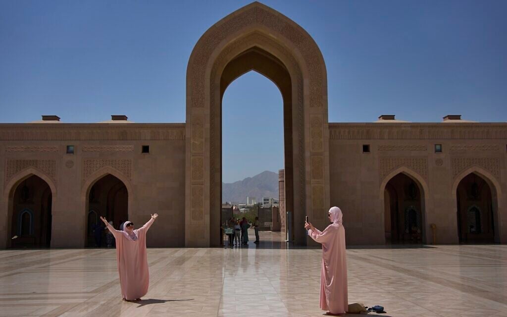 Tourists take photos at the Sultan Qaboos Grand Mosque in Muscat, Oman, Saturday, April 12, 2025. (AP Photo/ Fatima Shbair)