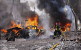 Firefighters put out fires sparked by a Russian missile attack that killed at least 21 people in the northeastern Ukrainian city of Sumy, April 13, 2025. (Ukrainian Emergency Services via AP)